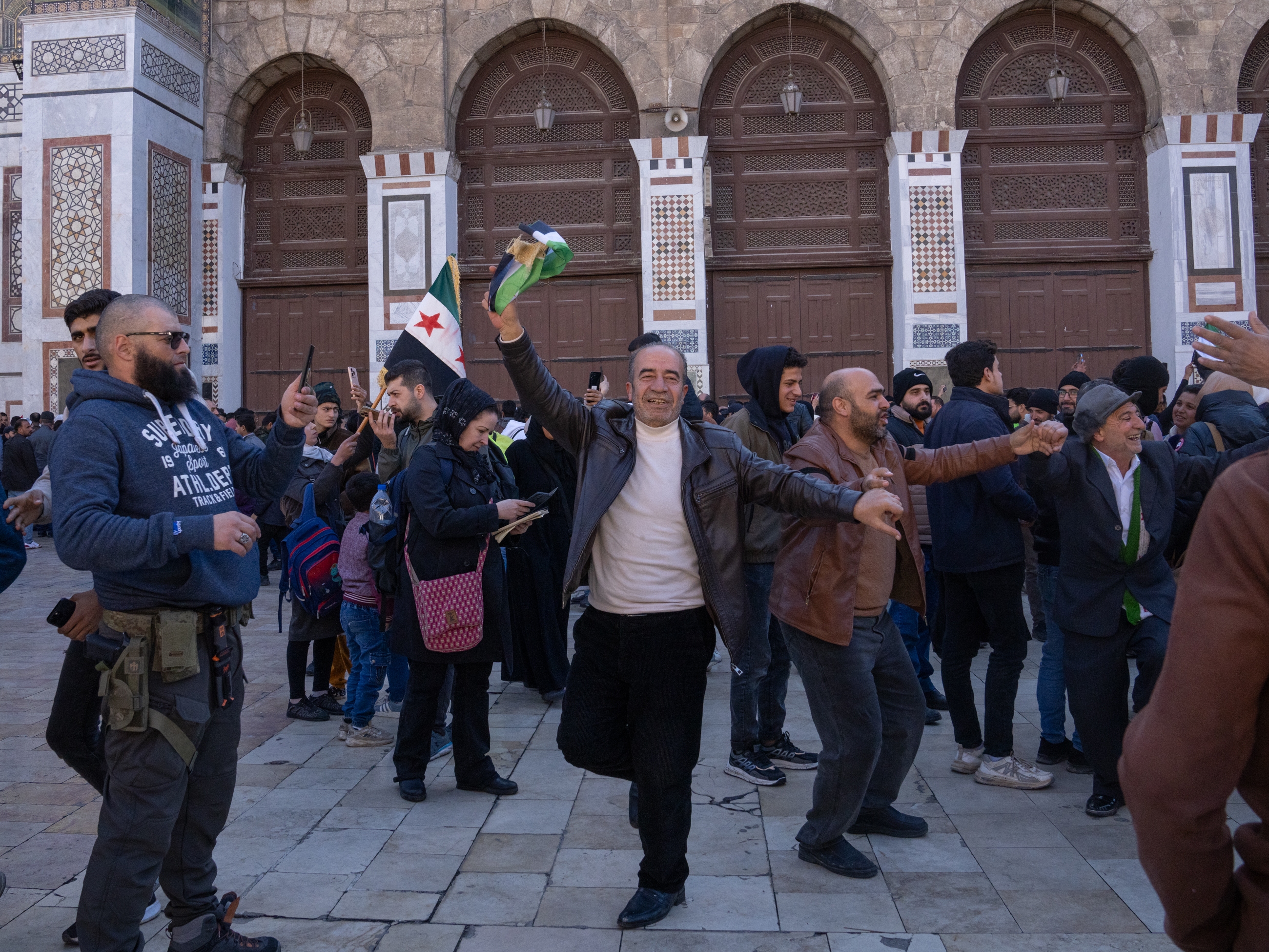 Men dance outside the Ummayad Mosque in Damascus, Syria, on Friday.