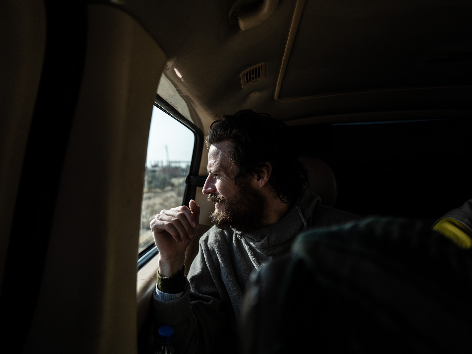 Travis Timmerman looks out the window of a van as he is taken to be handed over to U.S. forces near the Syrian border with Iraq and Jordan on Dec. 13.