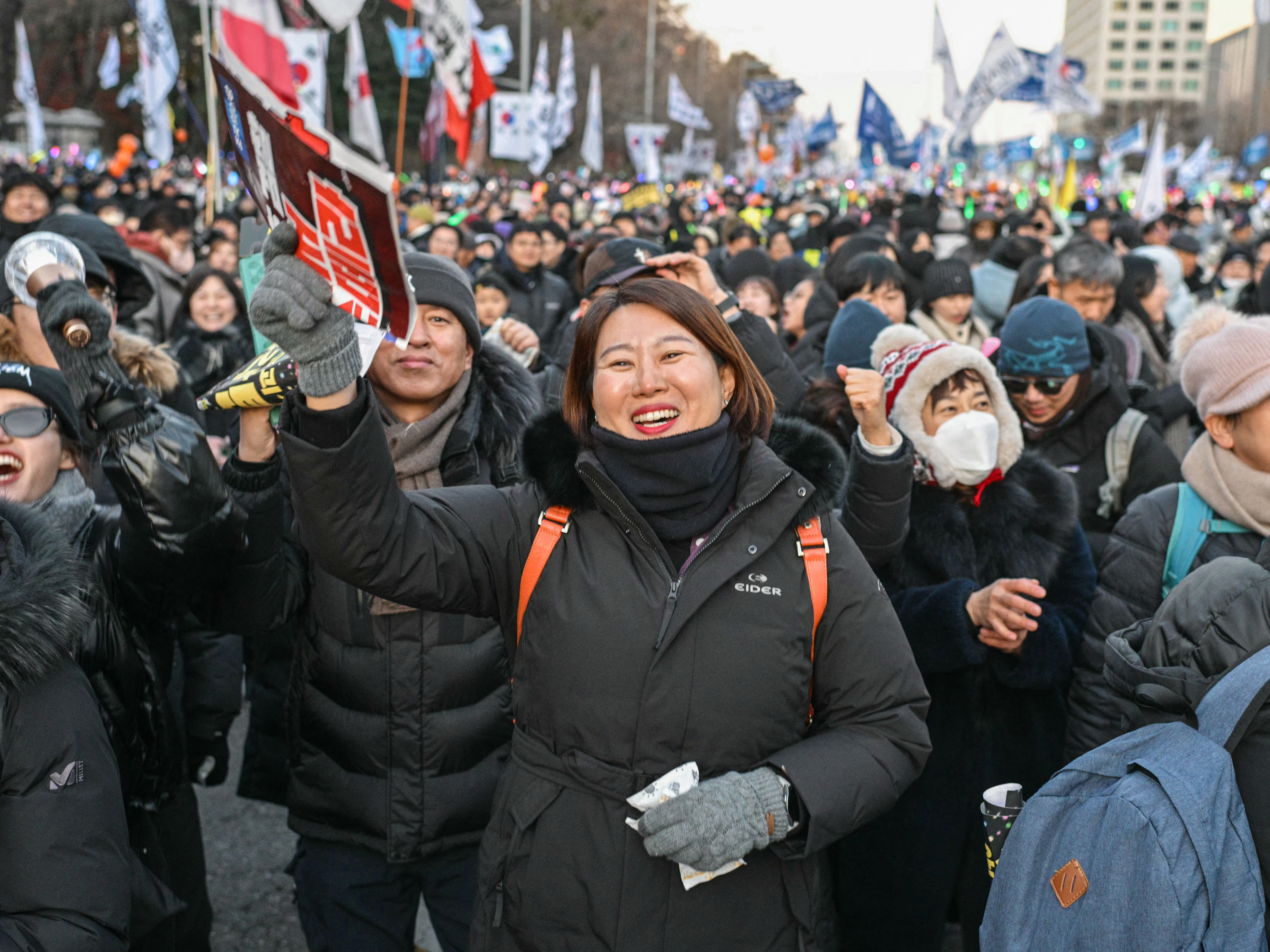 Protesters calling for the ouster of South Korea President Yoon Suk Yeol react after the result of the second martial law impeachment vote outside the National Assembly in Seoul, on Saturday.