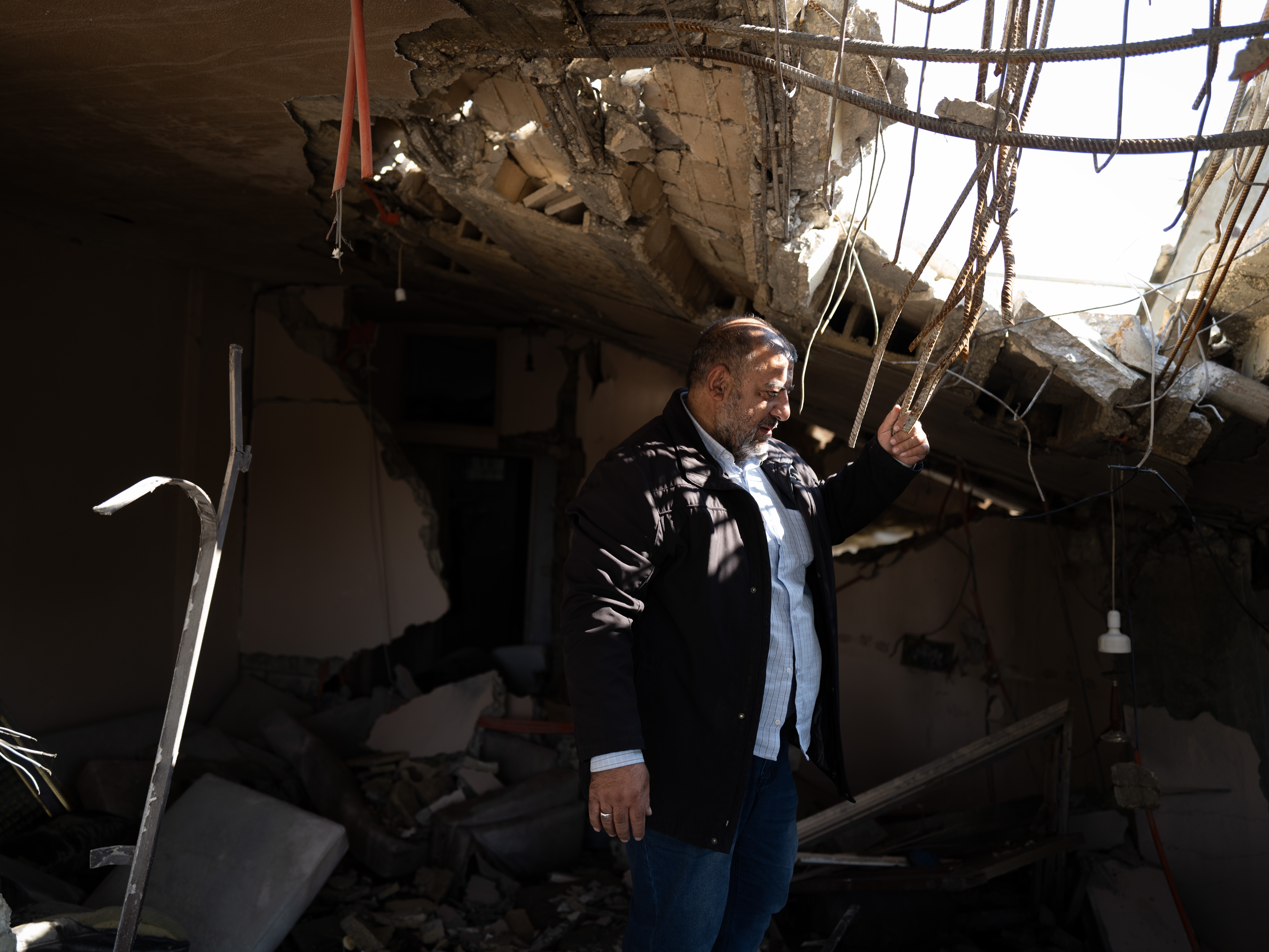 Khalil Moussa Shoumar, 55, stands in the rubble of his home. Shoumar is an auto parts seller whose house in Nabatieh was destroyed by Israeli airstrikes twice, first in 2006 and again in October.