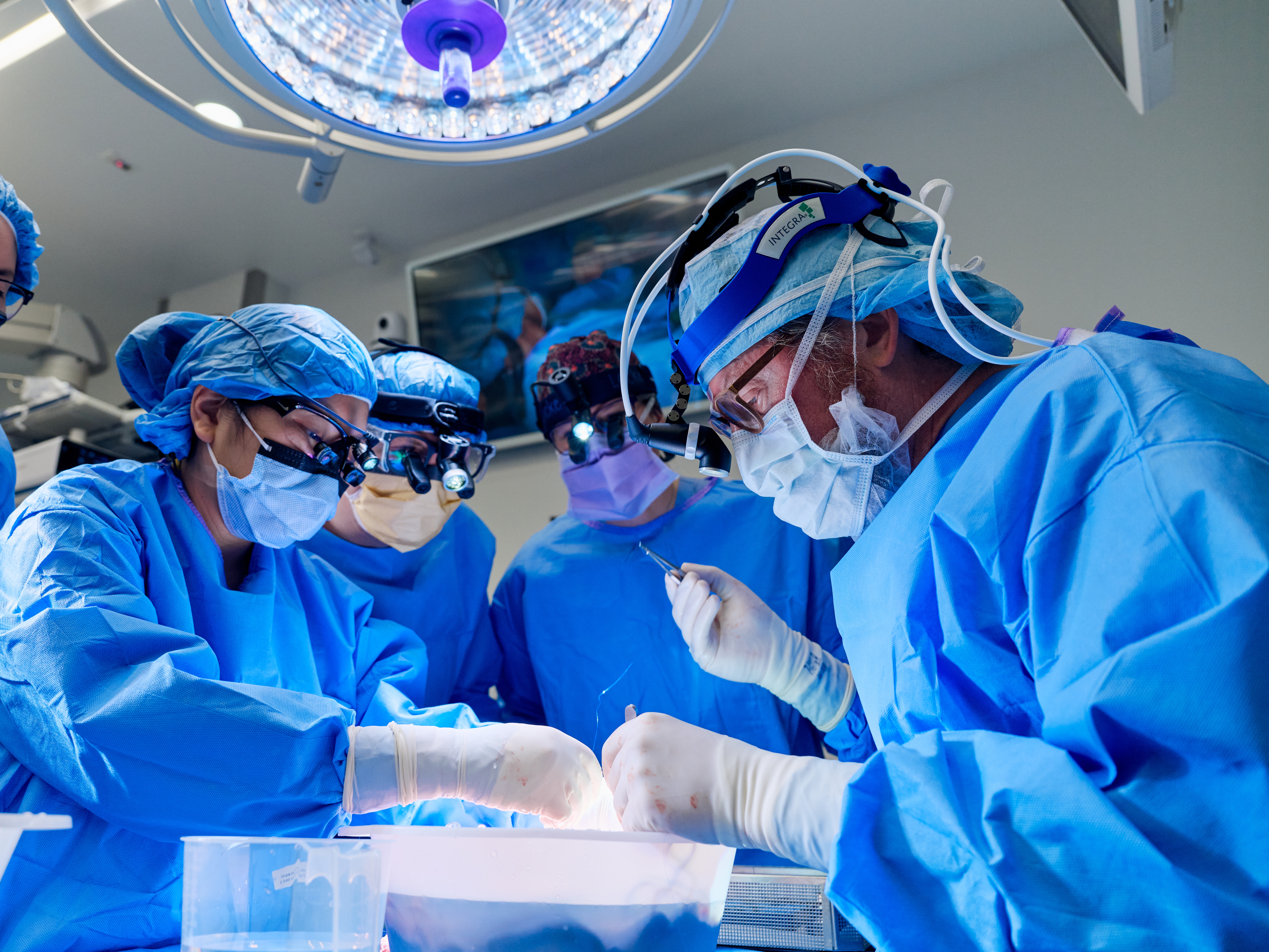 A surgical team at NYU Langone Health hospital, including Dr. Robert Montgomery (right), transplants a kidney from a genetically modified pig into patient Towana Looney, who's been on dialysis since 2016.