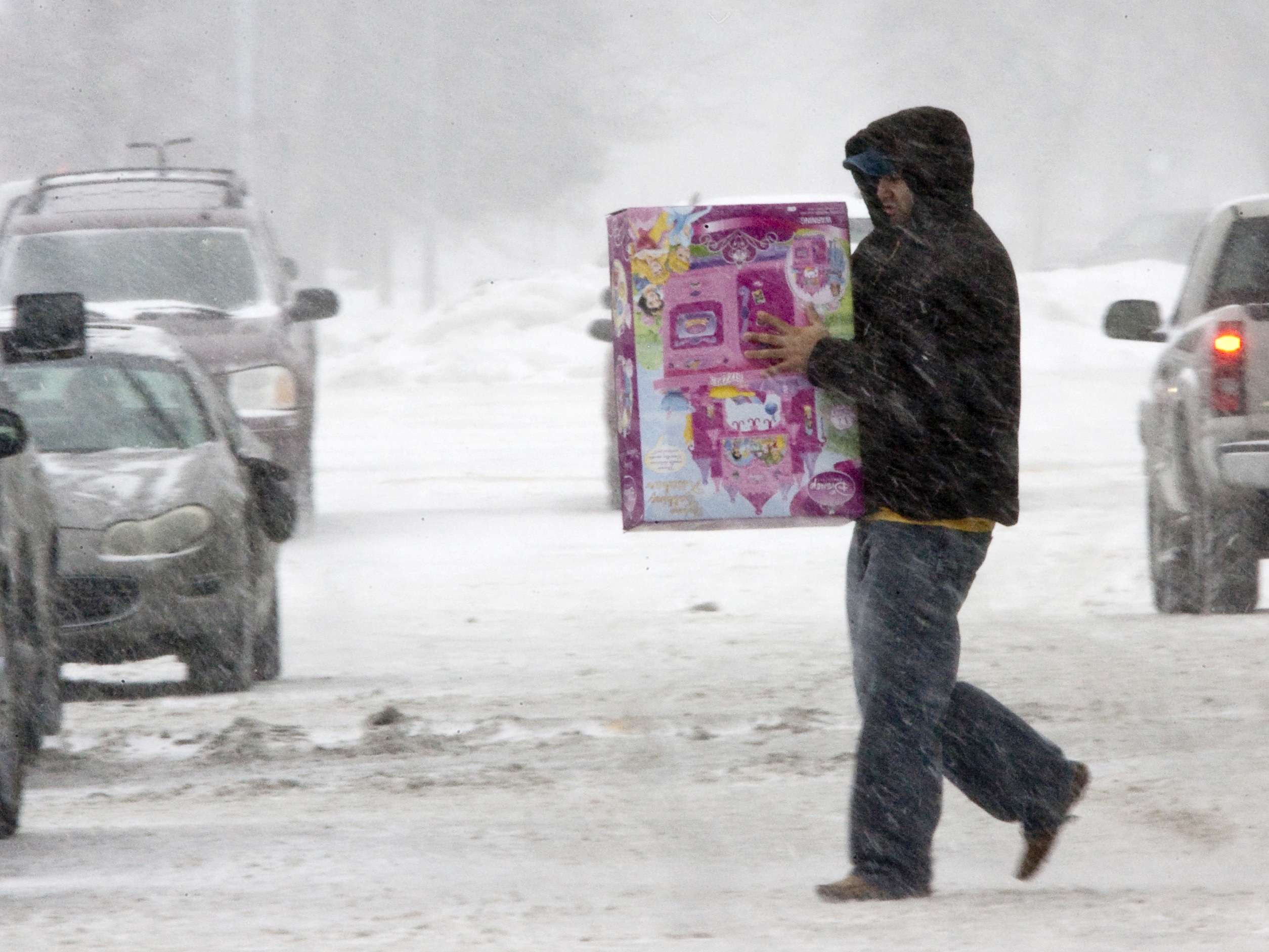 An unidentified person braves the weather to do last-minute shopping on Christmas Eve in Omaha, Neb., on Dec. 24, 2009. That year, a powerful storm spread snow, sleet and rain across the nation's midsection.