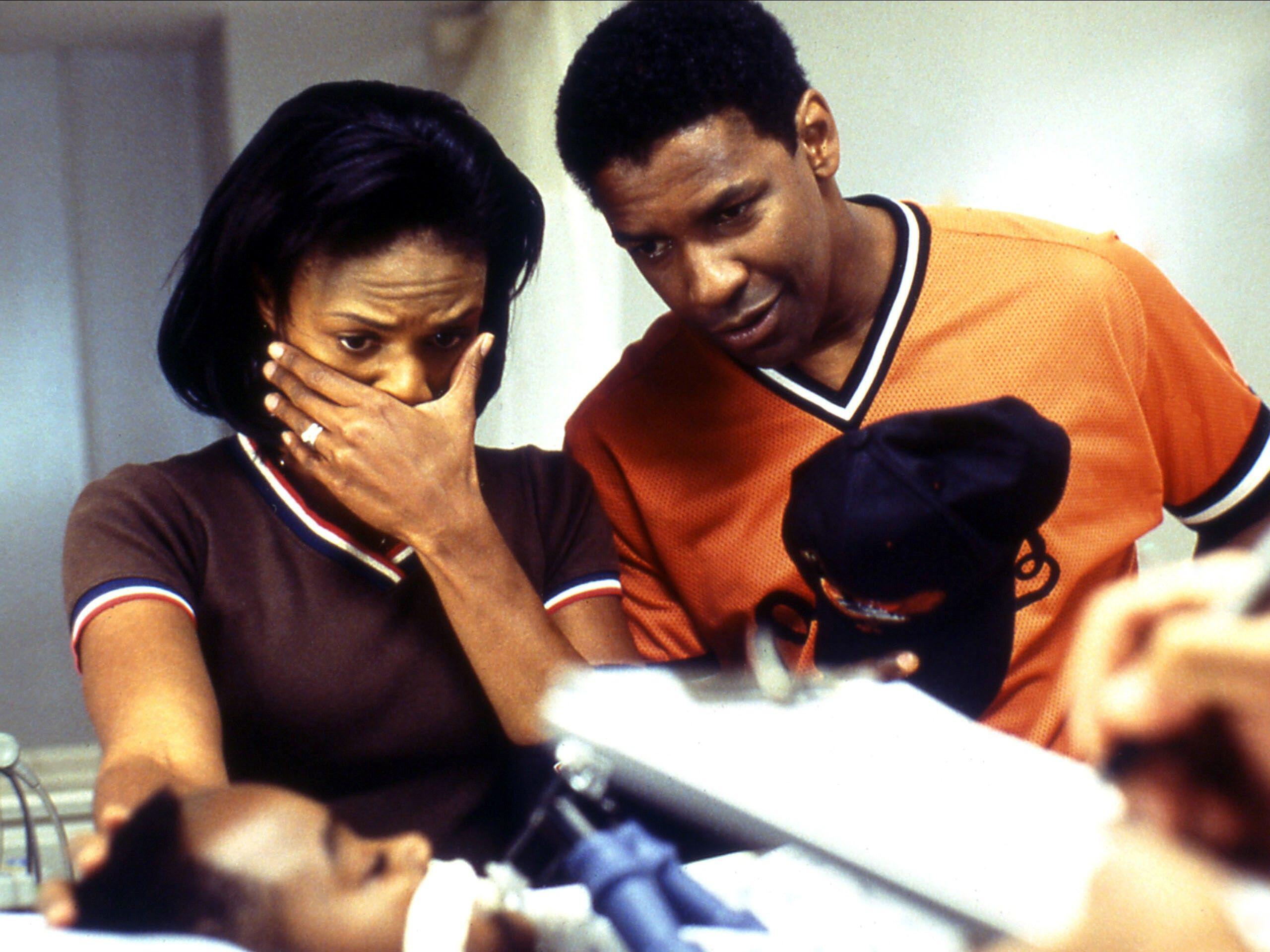 In the 2002 medical thriller <em>John Q, </em>Denzel Washington and Kimberly Elise play parents who learn that their 9-year-old son's heart transplant won't be covered by insurance.