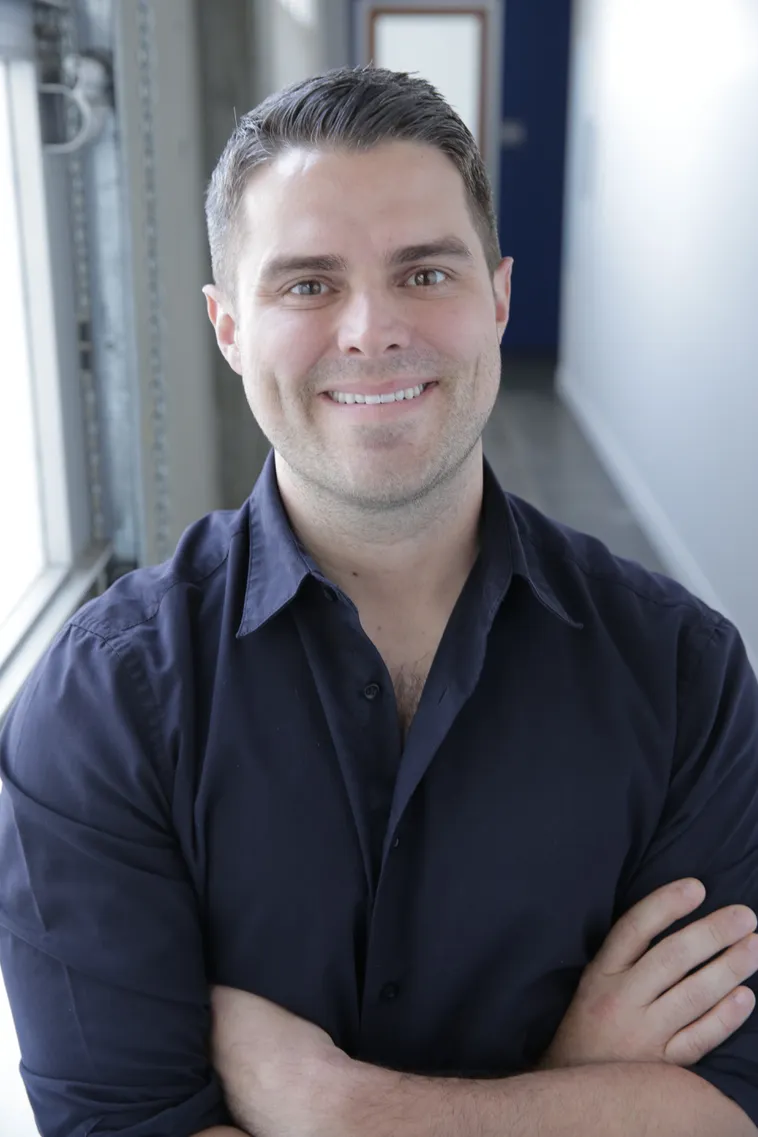 Man smiling in a button down shirt