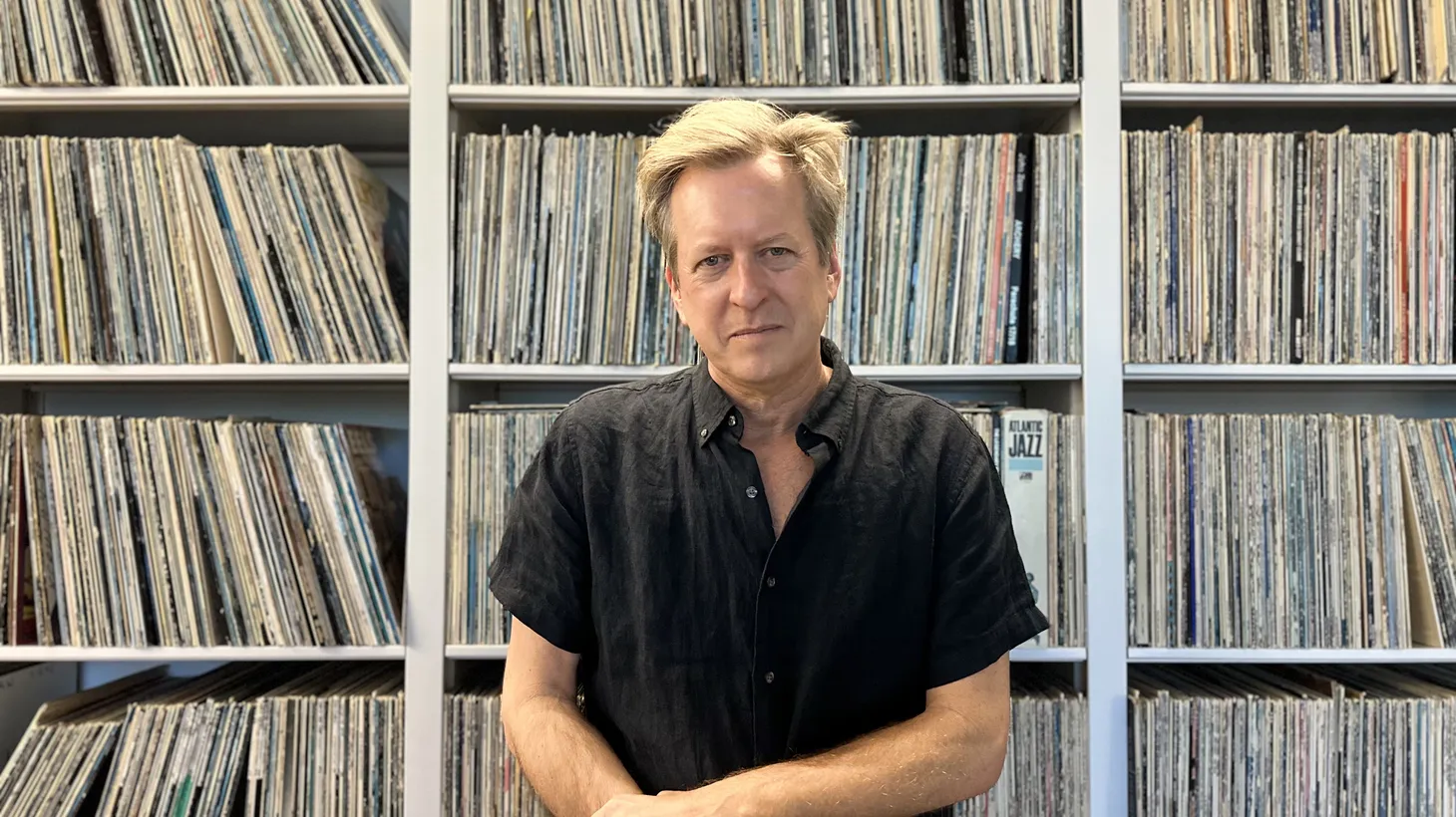 Just an artist, standing in front of a record wall, radiating genius.